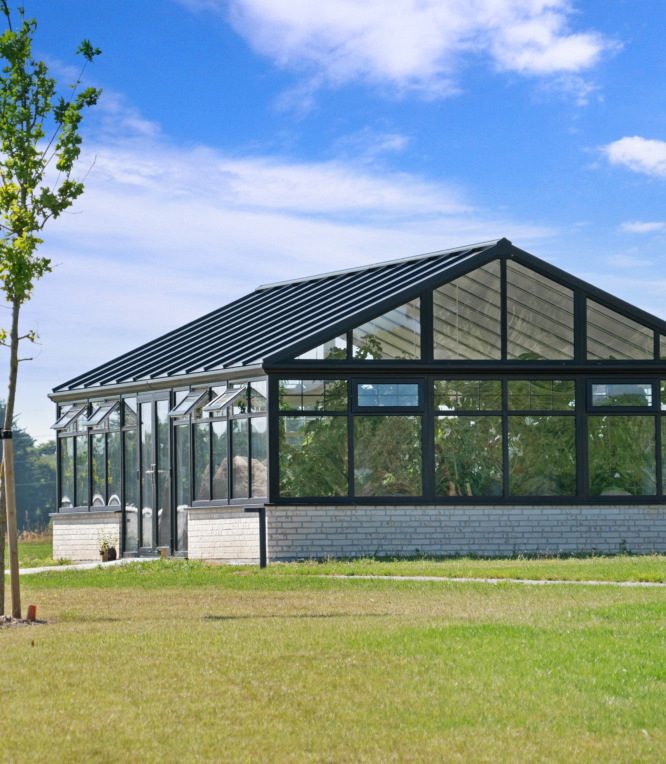 Large glazed garden building on a lawn